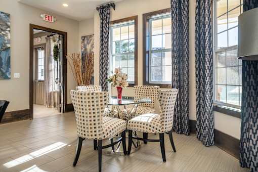 A dining room with a table set for two.