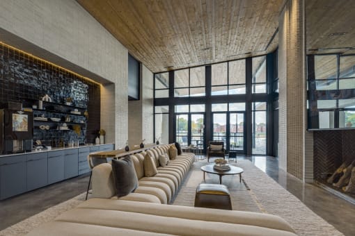 a living room with a large couch in front of a fireplace