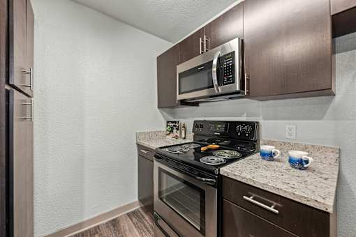 A modern kitchen with a stainless steel oven and microwave.