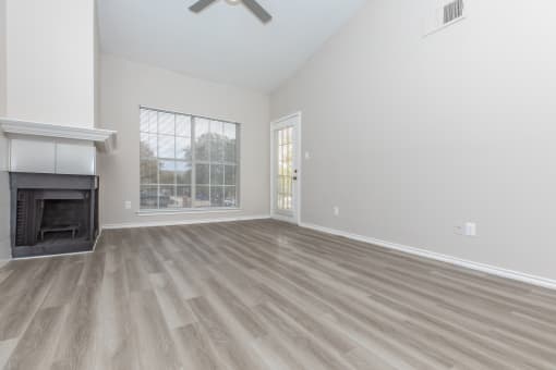a living room with a fireplace and a large window