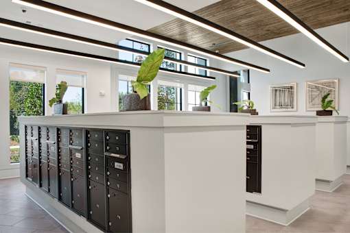 A long white reception desk with a black counterpart on the other side.