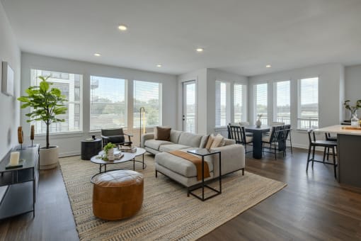 a living room with a couch and a table in front of a window