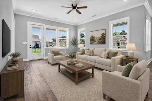 A living room with a couch, chair, and a television.