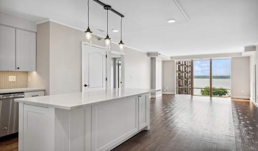 A modern kitchen with white cabinets and a large island.