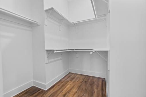 Empty room with white walls and wooden floor.