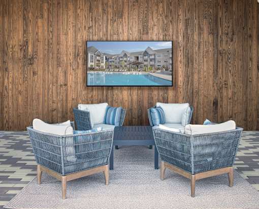 Two baby baskets in front of a wooden wall with a picture of a house and pool.