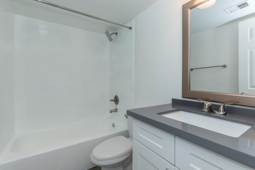 an empty bathroom with a sink toilet and shower