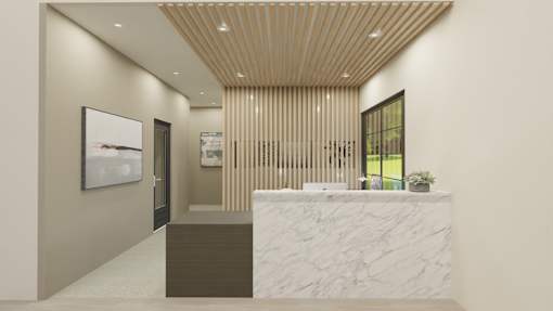A reception area with a marble counter and a framed picture on the wall.