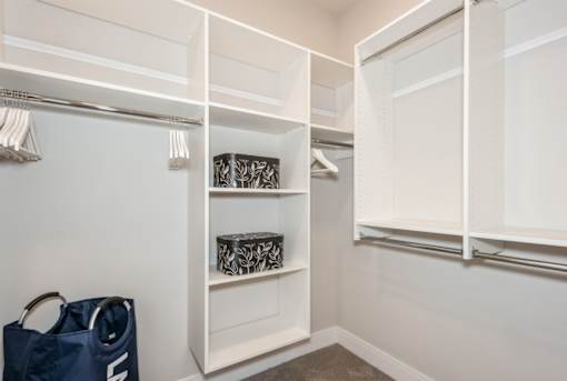 A white closet with a bag on the floor.