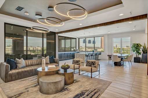 A modern living room with a large window and a view of the city.