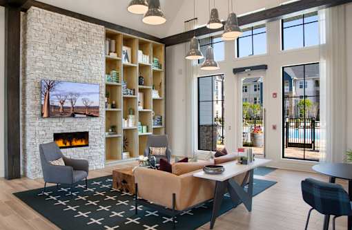 A living room with a fireplace and a large window.