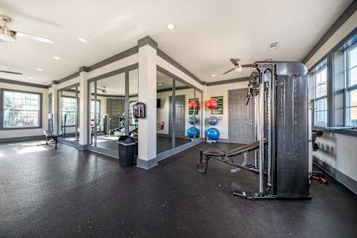 A spacious home gym with a variety of equipment.