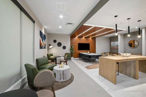 A modern living room with a large TV and a dining table.