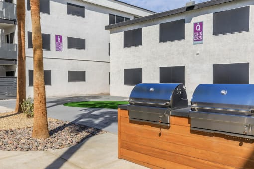 a picture of two bbq pits in front of a building
