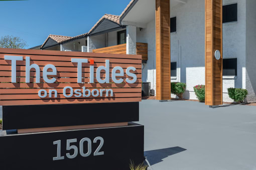 the tides on osborn sign in front of a building