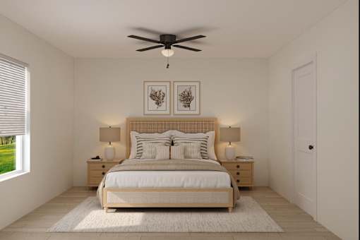 A bedroom with a large bed, two lamps, and a ceiling fan.