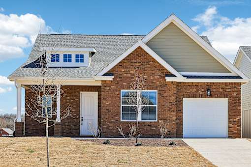 A house with a white door and a garage door.