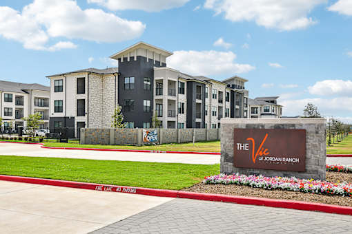 The Jordan Ranch apartments are located in a sunny, green area.