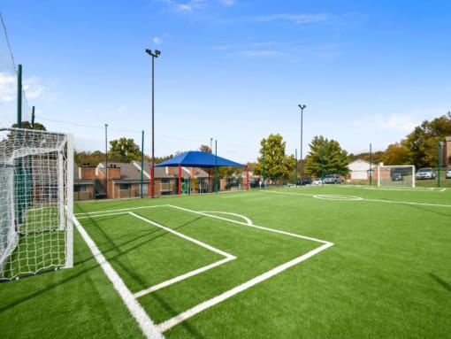 a soccer field at a school with a soccer goal on it