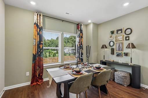 A dining room with a table set for a meal.