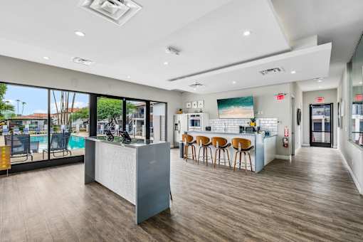 A modern kitchen with a bar area and wooden flooring.