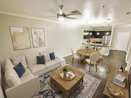 A living room with a beige couch, a wooden coffee table, and a ceiling fan.