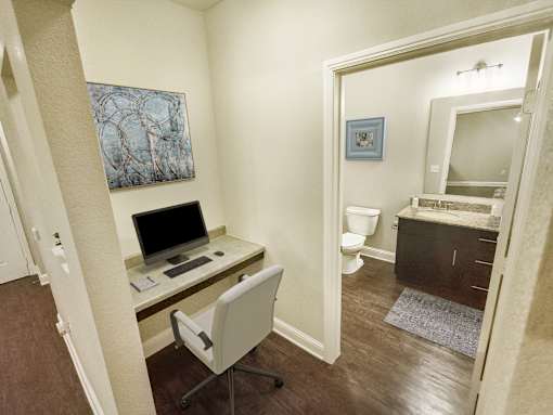 A room with a desk and a chair.