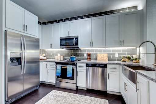 a kitchen with stainless steel appliances and white cabinets