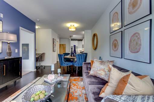 a living room with a couch and a table and a dining room