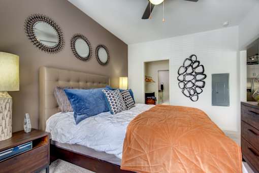 a bedroom with a bed and a ceiling fan