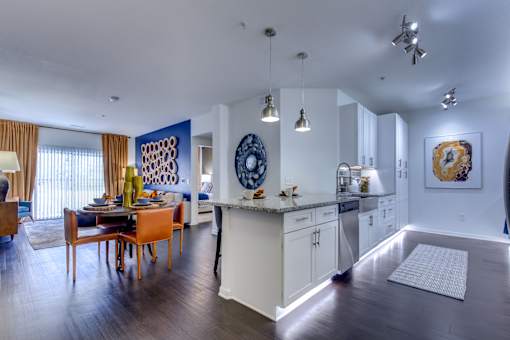 a kitchen and dining room with blue walls and a table and chairs