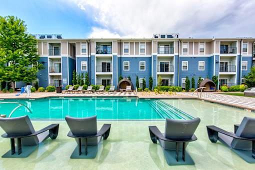 a swimming pool in front of an apartment building