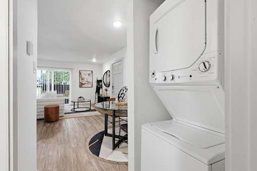 A white oven in a kitchen with a table and chairs in the background.
