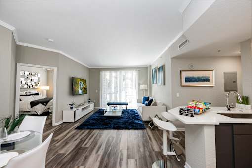 A modern kitchen with a dining table and chairs.