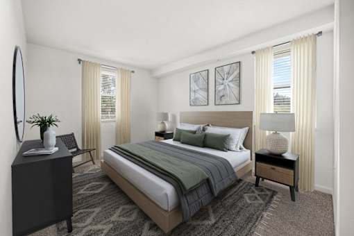 A bedroom with a large bed, a side table with a lamp, and a dresser with a mirror.