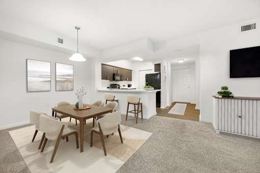 A modern dining room with a wooden table and chairs.