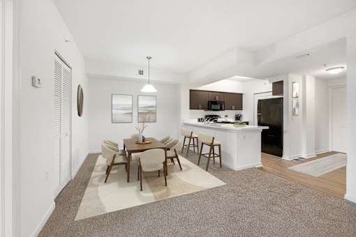 A dining room with a table set for six.