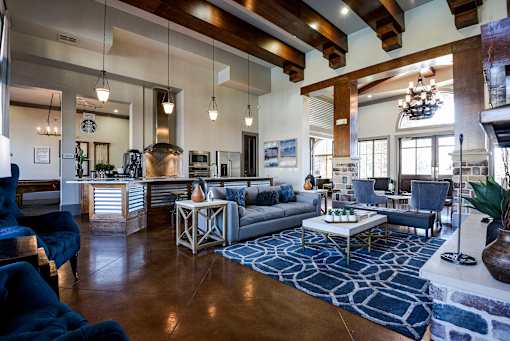 a living room with couches and chairs and a kitchen