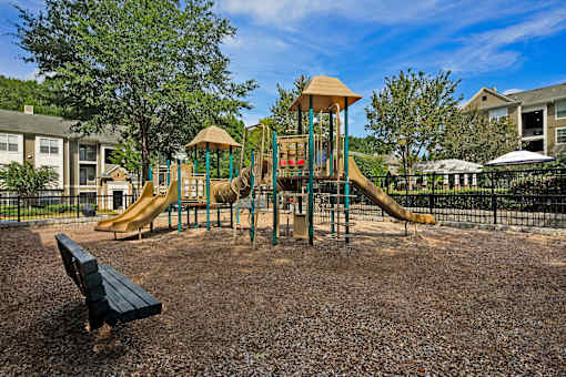 A playground with a slide and a wooden structure.