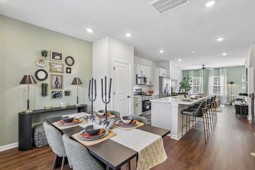 A modern dining room with a table set for a meal.