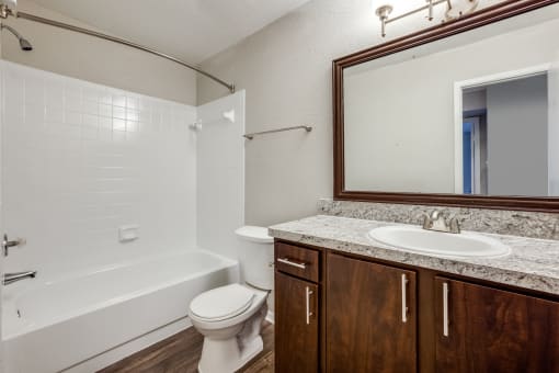 a bathroom with a sink toilet and bath tub