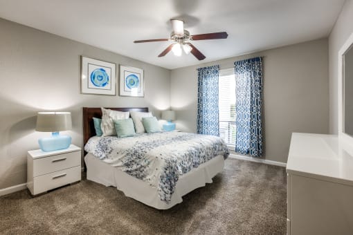 a bedroom with a bed and a ceiling fan