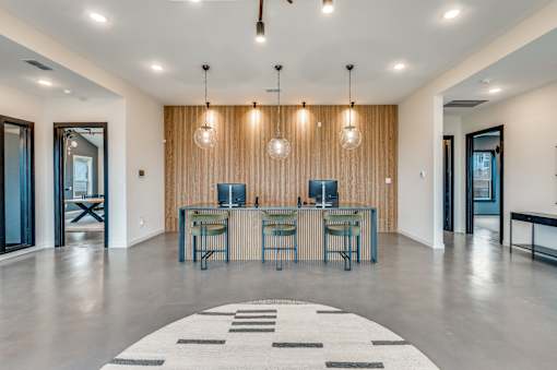 A modern room with a long table and chairs.