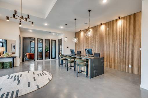 A modern dining room with a long table and chairs.