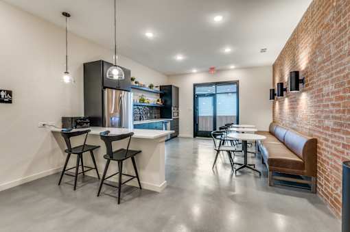 A modern kitchen with a bar area and seating.