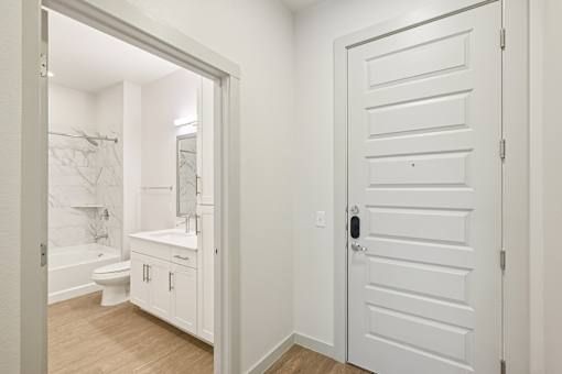 A white bathroom with a toilet, sink, and bathtub.