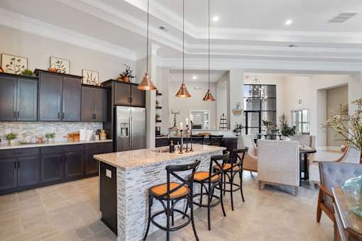 A modern kitchen with a bar area and a dining table.