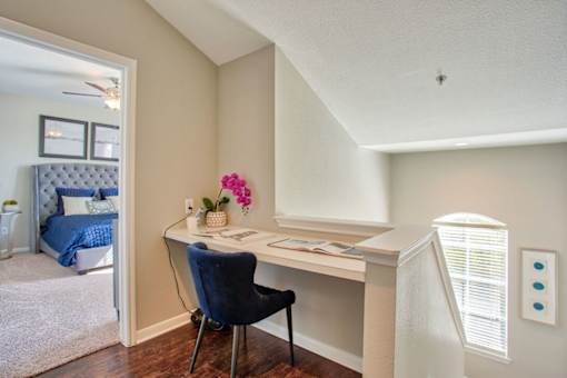 A room with a desk and a chair.