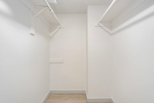 A white room with a wooden floor and white walls.