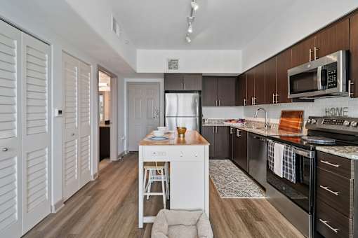 A kitchen with a white fridge and wooden cabinets.